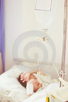 Illness asian boy lying on sickbed in hospital