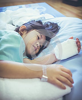 Illness asian child admitted in hospital with saline iv drip on
