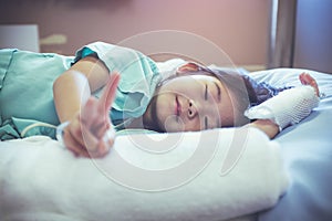 Illness asian child admitted in hospital with saline iv drip on