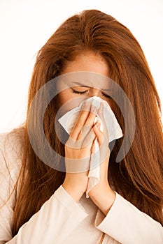 illness flu - Young Woman Lying On Bed Infected With Allergy Blowing Her Nose