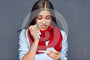 Illness woman holding thermometer and paper tissue