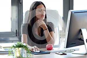 Illness young business woman with terrible throat pain working with computer in the office