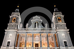 Illuminated Almudena Cathedral facade in Madrid, Spain