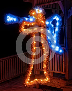 Illuminated angel with horn at nighttime gazebo