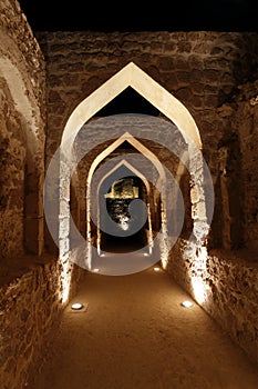 Illuminated archway inside Bahrain fort
