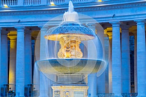 Illuminated Bernini Fountain at St Peters Basilica in the evening dusk. St Peters Square, Vatican