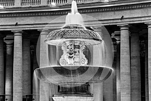 Illuminated Bernini Fountain at St Peters Basilica in the evening dusk. St Peters Square, Vatican