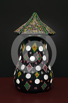 Illuminated black painted pottery table lamp photo