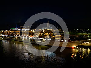 Illuminated bow and starboard of a cruise ship at night Southampton Port UK