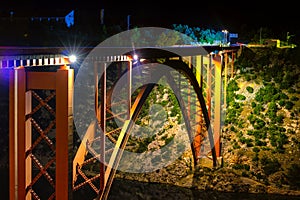 Illuminated bridge at night, steel arch construction