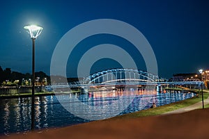 Illuminated Bridge Over Vistula River at Night in Krakow