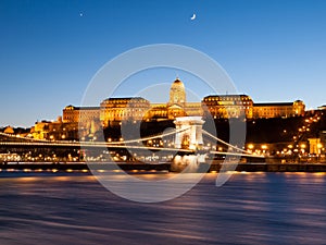 Illuminated Buda Castle and Chain Bridge over Danube River in Budapest by night, Hungary