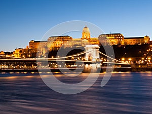 Illuminated Buda Castle and Chain Bridge over Danube River in Budapest by night, Hungary