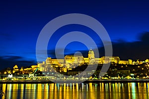 Illuminated building of Buda Castle and Chain bridge at night in