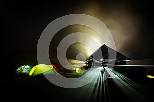 Illuminated camping tents at night in alpin zone photo