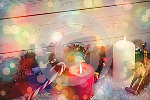 Illuminated candles with Christmas decorations