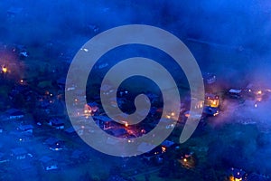 The illuminated chalets of the town of Les Houches in the Mont Blanc massif in Europe, France, the Alps, towards Chamonix, in