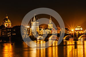 Illuminated Charles Bridge,Karluv most reflected in Vltava River. Evening panorama of Prague, Czech Republic. Long exposure city