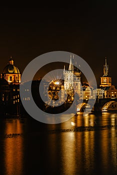 Illuminated Charles Bridge,Karluv most reflected in Vltava River. Evening panorama of Prague, Czech Republic. Long exposure city