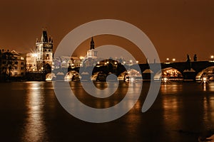 Illuminated Charles Bridge,Karluv most, reflected in Vltava River. Evening panorama of Prague, Czech Republic. Long exposure city