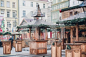 Illuminated Christmas fairground with wooden kiosk with a lot of bright decorations, without logos