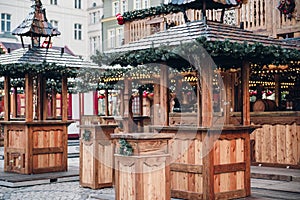 Illuminated Christmas fairground wooden kiosk with a lot of bright decorations, without logos