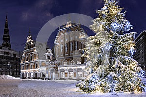 Illuminated Christmas tree at night. Town Hall square with House of the Blackheads and Christmas tree in winter, old town Riga,