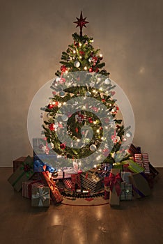 Illuminated christmas tree with presents photo