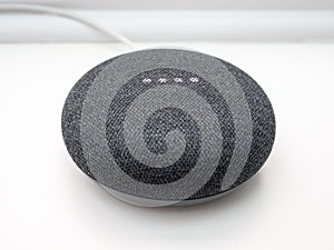 Illuminated close up of smart home bluetooth speaker on white background photo