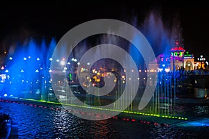 Illuminated colored night fountain in the city