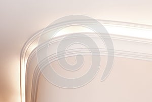 Illuminated cornice, bright interior background