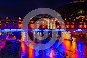 illuminated covered bridge reflecting on Osam river in the bulgarian city Lovech...IMAGE