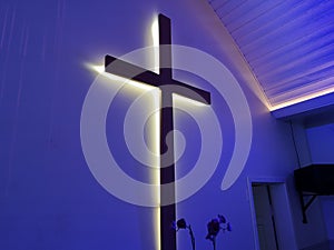 Illuminated Cross Mounted On The Wall Of Modern Church