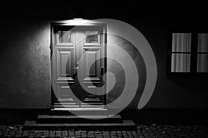 Illuminated door with stairs at night