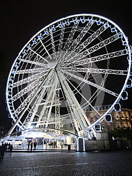 illuminated fairground wheel on a cold night photo