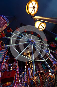 Illuminated ferris wheel in an indoor playgroud photo