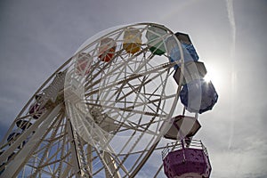 Illuminated ferris wheel with vibrant rides in Tibidabo, Barcelona, Spain