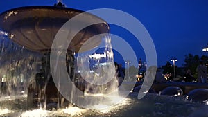 Illuminated fountain closeup at night