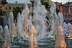 Illuminated fountain in the evening city