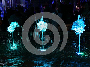 Illuminated fountain in the evening in the park a background