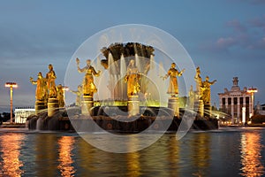 Illuminated Fountain of Friendship of People at Twilight