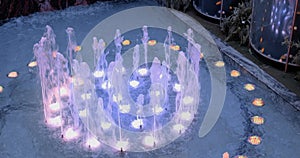 Illuminated fountain in the shopping center. Colored fountain in the mall