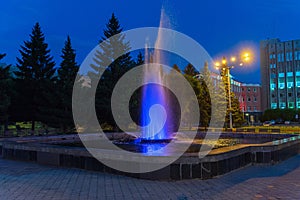 Illuminated fountain in the square in front of the municipality. Abakan. Khakassia