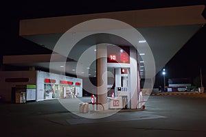 Illuminated gas station at night