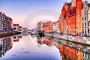 Illuminated Gdansk Old Town with Calm Motlawa River at Sunrise, Poland