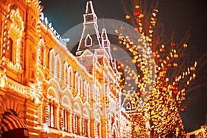 Illuminated GUM facade and New year festive decorations on Red Square, main landmark in Moscow. Christmas fair in Russia