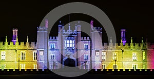 Illuminated Hampton Court Palace by night in Hampton Court, London, UK