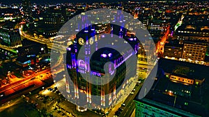 Illuminated historic building at night in urban skyline in Liverpool, UK