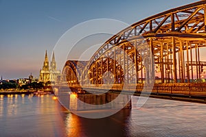 The illuminated Hohenzollern Bridge with the famous Cologne Cathedral