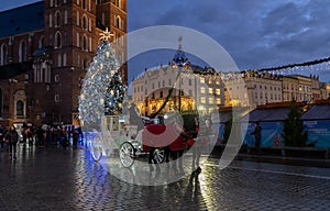 Illuminated horse drawn carriage at Main Market Square at Christmas time. Krakow, Poland